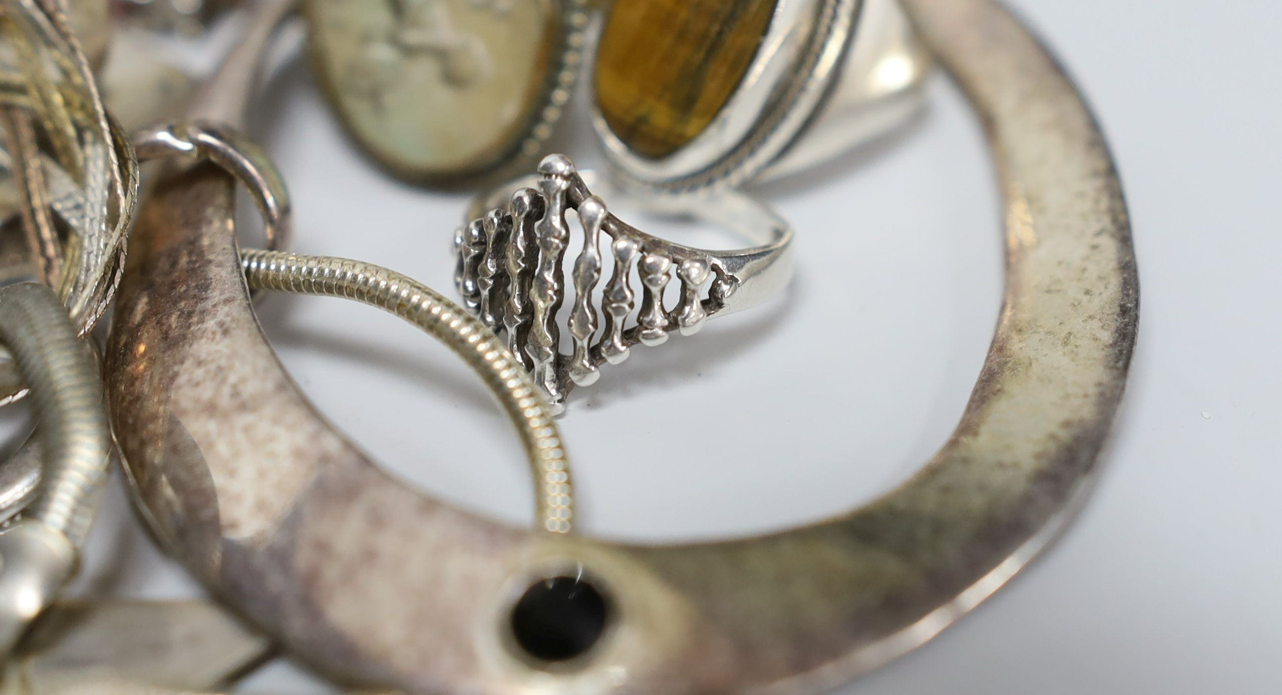 A quantity of assorted silver and white metal jewellery etc. including albert chain with pocket watch, bangles, bracelets, brooches, money clip and rings.